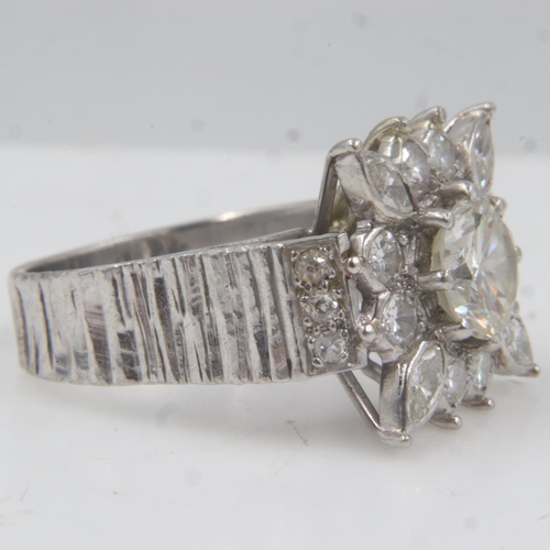 31 - Large heavy gauge diamond-set platinum cocktail ring, the central cushion-cut stone approximately 1.... 