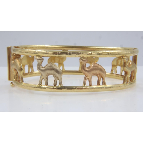 42 - Middle-Eastern 18ct gold hinged bangle by Shazar, pierced with camel design, 70 x 50 mm, 26.3g. UK P... 