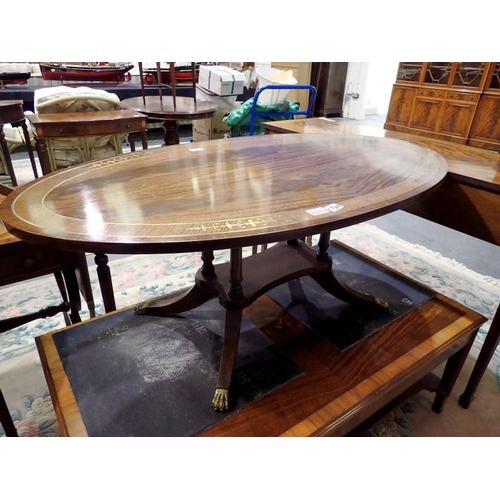 1724 - Mahogany inlaid oval coffee table raised on quad base with brass lion paw feet, 122 x 70 x 47 cm H. ... 