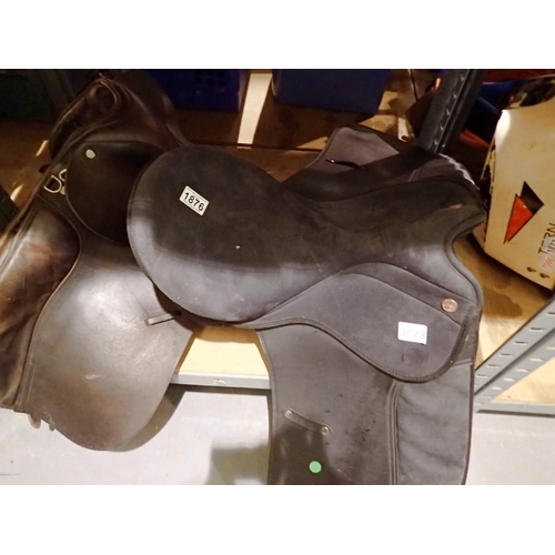 1876 - Black riding saddle and a brown leather riding saddle. Not available for in-house P&P