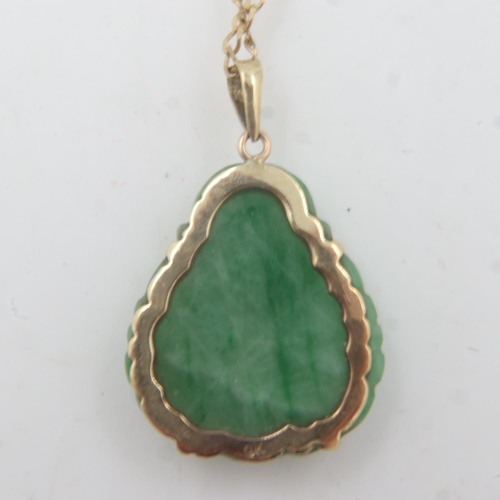 52 - A 9ct gold mounted carved jade pendant in the form of a Buddha, drop L: 25 mm, on a 9ct gold chain, ... 