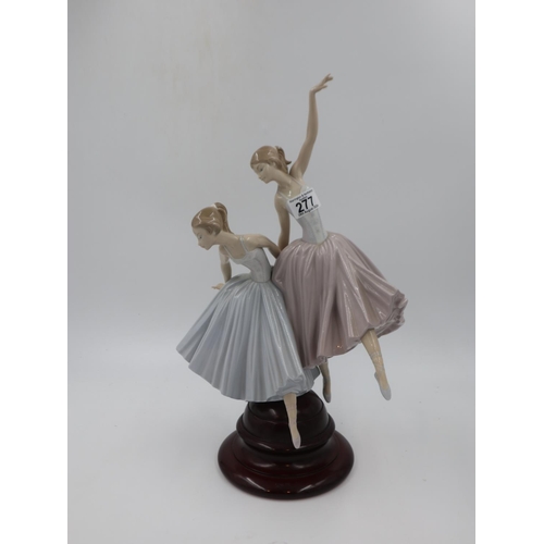 277 - Lladro large figural group modelled as a pair of ballerinas raised on a turned mahogany base, overal... 