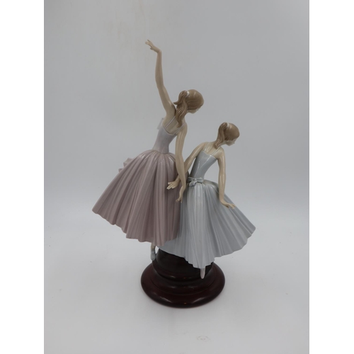 277 - Lladro large figural group modelled as a pair of ballerinas raised on a turned mahogany base, overal... 