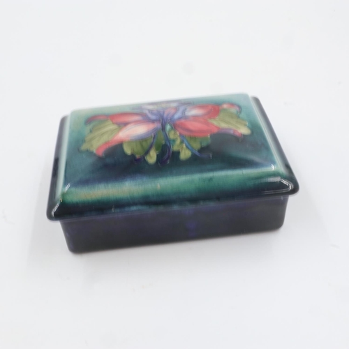 301 - Moorcroft rectangular lidded trinket box in the Columbine pattern on graduated green/blue ground. L:... 