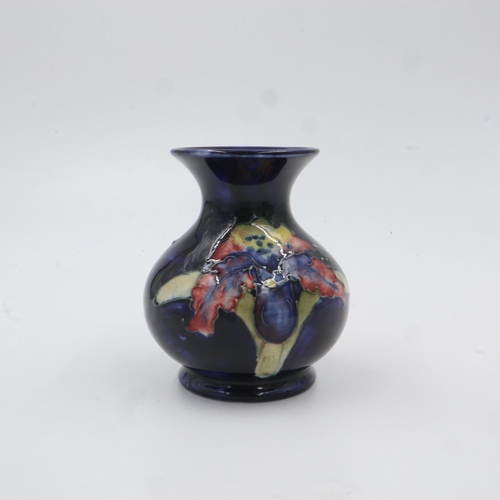 313 - Moorcroft vase in the Orchid pattern on cobalt blue ground. H: 9.5cm. UK P&P Group 1 (£16+VAT for th... 