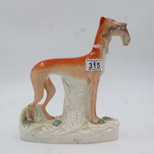 315 - Staffordshire model of a lurcher with a rabbit in its jaws, H: 27cm. UK P&P Group 3 (£30+VAT for the... 