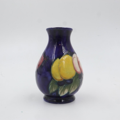 322 - Moorcroft vase in the Wisteria pattern on cobalt blue ground. H: 9.5cm. UK P&P Group 1 (£16+VAT for ... 