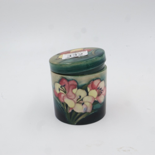 332 - Moorcroft lidded pot in the Freesia pattern, (ill fitting lid), with a lidded box in the Hibiscus pa... 