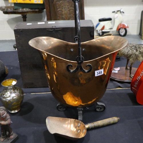 348 - Copper helmet shaped coal bucket with copper hand shovel, bucket raised on wrought iron feet and has... 