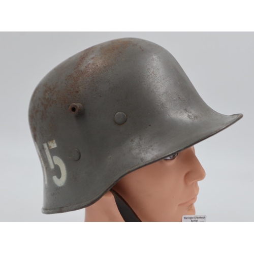 2107 - Excellent example of a WWI Stahlhelm Helmet, with civil liner and chinstrap. This re-used WWI helmet... 