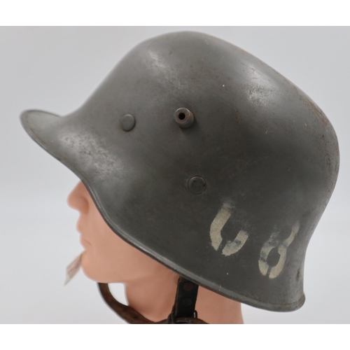 2107 - Excellent example of a WWI Stahlhelm Helmet, with civil liner and chinstrap. This re-used WWI helmet... 