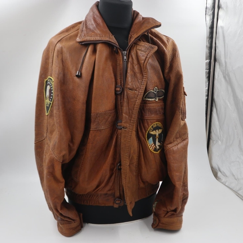 2168 - An American USAF brown leather flying jacket, with sewn patches, approximate size M. UK P&P Group 2 ... 