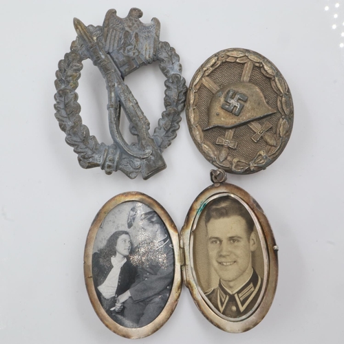 2189 - Oval silver plated locket containing two photographs of a WWII German soldier, together with Infantr... 