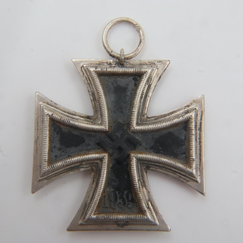 2197 - WWII Iron Cross 2nd Class. Hooked on an eagle-form stand. One of the bullet heads is missing. UK P&P... 