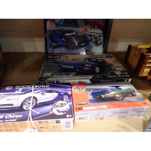 1011 - Four model car plastic kits, Airfix Bugatti Chiron and E type Jag, Revell New Type Beetle and Revell... 