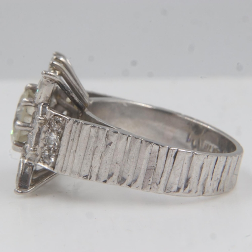 32 - Large heavy gauge diamond-set platinum cocktail ring, the central cushion-cut stone approximately 1.... 