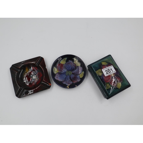 201 - Three pieces of Moorcroft with damages, including a flambé Hibiscus ashtray, Clematis pin dish and a... 