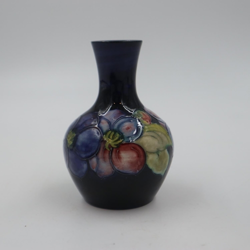 278 - Moorcroft vase in the clematis pattern on a cobalt blue ground, original paper label to base, H: 12 ... 