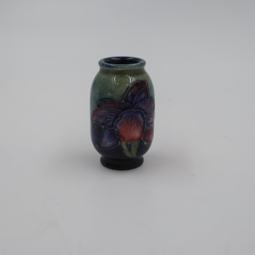 283 - Moorcroft miniature vase in the clematis pattern on a graduated green to blue ground, H: 55 mm. UK P... 