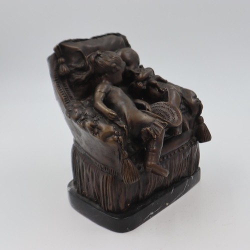 302 - Bronze sculpture of two children on an over stuffed chair, raised on a marble base, H: 22 cm. UK P&P... 