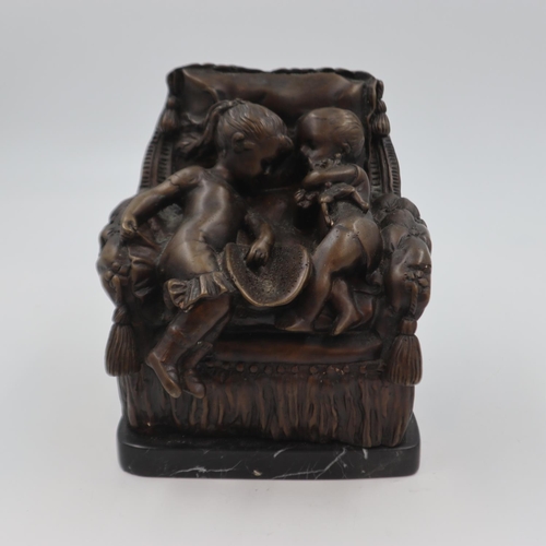 302 - Bronze sculpture of two children on an over stuffed chair, raised on a marble base, H: 22 cm. UK P&P... 