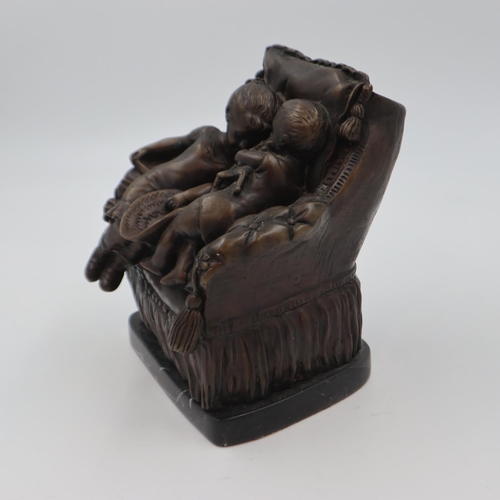 302 - Bronze sculpture of two children on an over stuffed chair, raised on a marble base, H: 22 cm. UK P&P... 