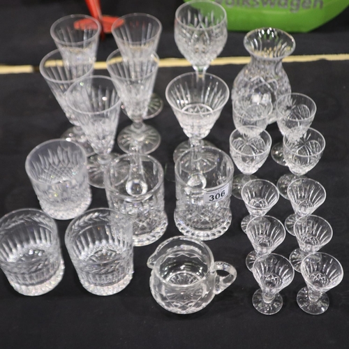 306 - Suite of crystal and cut glass drinking glasses together with a small water jug and a vase, mostly W... 