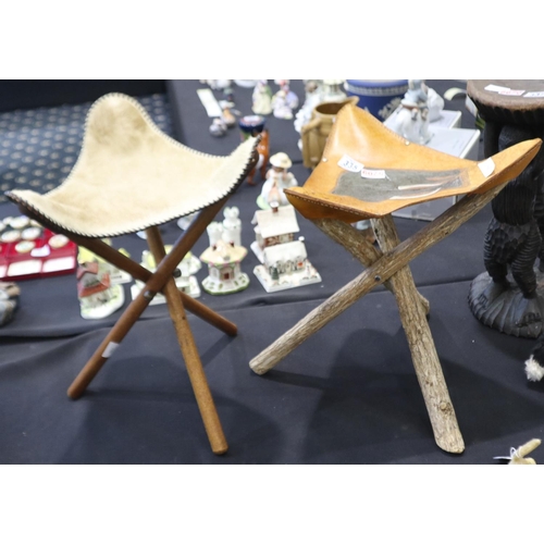 335 - Two carved African stools with leather and hide seat covers. Not available for in-house P&P