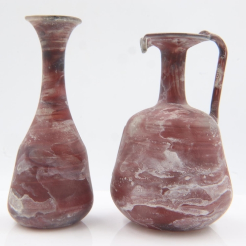 100 - Late Roman Byzantine period mottled glass miniature ewer and similar bottle vase, likely for the use... 