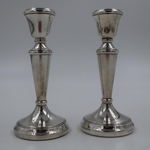 121 - Pair of sterling silver candlestick holders with weighted bases, overall 276g (filled), H: 15 cm, da... 