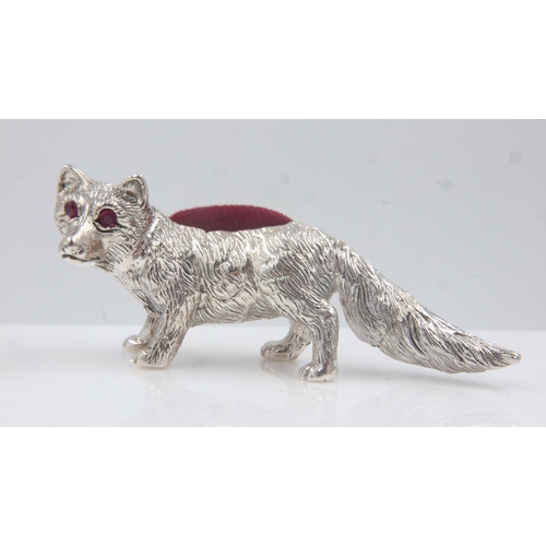 129 - Silver fox form pin cushion with sapphire eyes. UK P&P Group 1 (£16+VAT for the first lot and £2+VAT... 