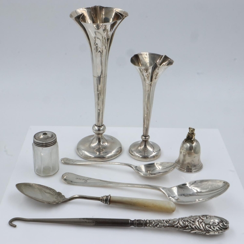 139 - Mixed sterling silver items to include two spoons (combined 38g), with two weighted bud vases a moth... 