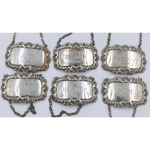 142 - A matched set of six (two sets of three) hallmarked silver decanter labels, combined 84g. UK P&P Gro... 