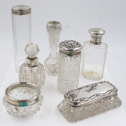 143 - Group of silver collared and silver topped glass bottles and pots, total weight of the removable top... 