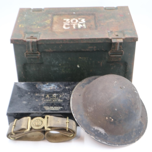 2099A - British Home Front: ARP brodie helmet and first aid tin, with a regimental belt and 303 ammunition t... 