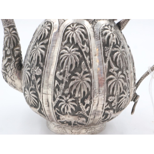 132A - 19th century Raj period Indian silver teapot, the body having designs of palm trees and indigenous a... 