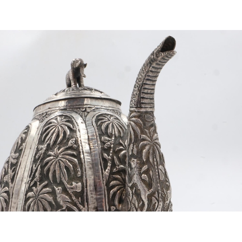 132A - 19th century Raj period Indian silver teapot, the body having designs of palm trees and indigenous a... 