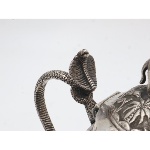 132A - 19th century Raj period Indian silver teapot, the body having designs of palm trees and indigenous a... 