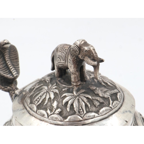 132A - 19th century Raj period Indian silver teapot, the body having designs of palm trees and indigenous a... 