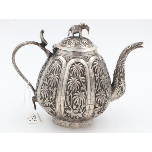 132A - 19th century Raj period Indian silver teapot, the body having designs of palm trees and indigenous a... 