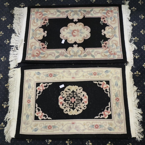 2097 - Pair of 20th century Chinese thick pile rugs with floral design against a black ground, each 100 x 6... 