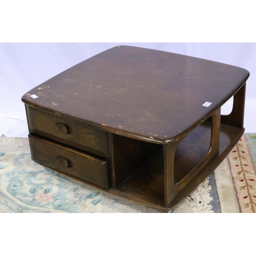 2110 - Ercol dark elm Pandoras Box square form centre table with two drawers and shelves, raised on shepher... 