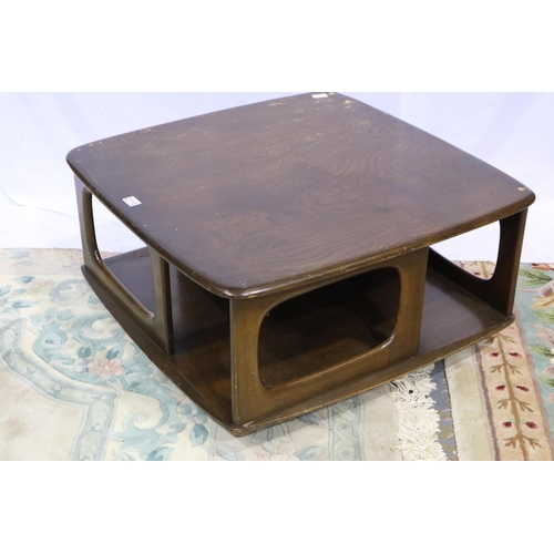 2110 - Ercol dark elm Pandoras Box square form centre table with two drawers and shelves, raised on shepher... 