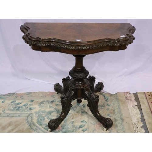 2114 - 19th century walnut fold over card table with extensively carved quadripartite support, the interior... 