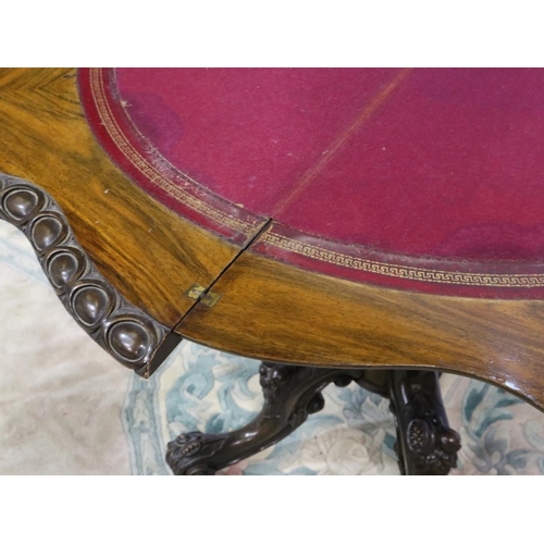 2114 - 19th century walnut fold over card table with extensively carved quadripartite support, the interior... 