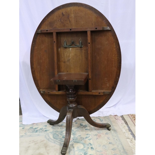 2126 - Victorian oval mahogany breakfast table, with hinged tilt-top raised on a quadripartite carved base,... 