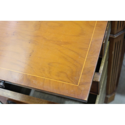 2140 - A reproduction yew twin pedestal partners desk, with inverted-break front to each side, three panels... 