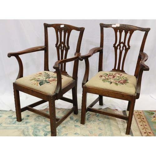 2146 - A pair of early 19th century mahogany elbow chairs, in the Chippendale style, with carved backrest a... 