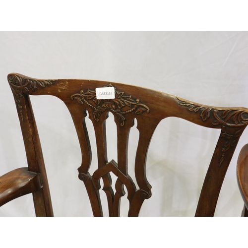 2146 - A pair of early 19th century mahogany elbow chairs, in the Chippendale style, with carved backrest a... 