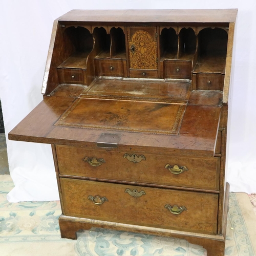 2147 - *KEYS IN OFFICE* An early 18th century walnut bureau, with stepped fitted interior, two short above ... 